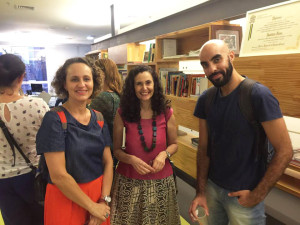 Foto com duas mulheres e um Homem Sorrindo para a câmera.